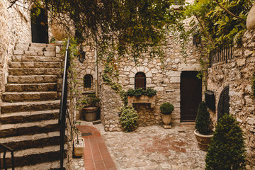 stairs at small atrium of ancient stone building, Eze, France