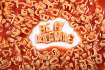 'Be my Valentine' written in spaghetti pasta letters for Valentines Day.