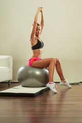 woman doing fitness exercises with fit ball