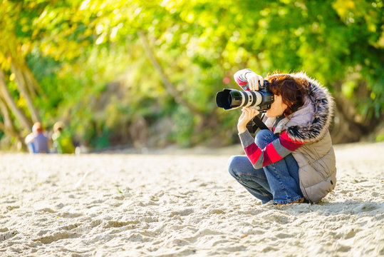 Woman photographer taking picture outdoor