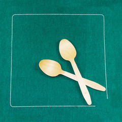 Wood Spoons on a green the napkin  - 198609039