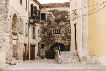 Fototapeta na wymiar narrow street with ancient buildings at old european town, Sainte Agnes, France