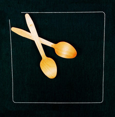 Wood Spoons on a black the napkin - 198614080