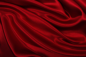 Smooth elegant red silk or satin luxury cloth texture as abstract background. Luxurious background design