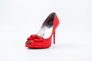 red female shoes with a bow on a white background 