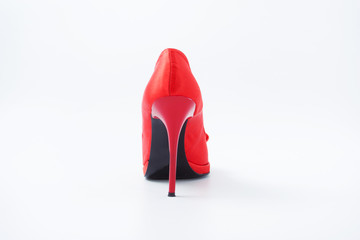 red female shoes with a bow on a white background 