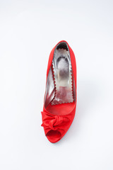 red female shoes with a bow on a white background 