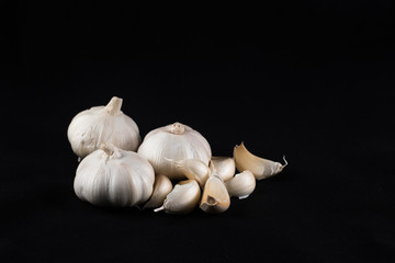 fresh garlic and peeled garlic  isolated on black background. food ingredients and cooking concept