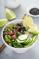 Poke bowl with raw tuna, rice and vegetables