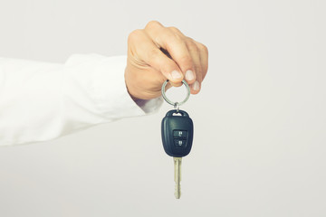 Businessman holding the  car key, isolated background