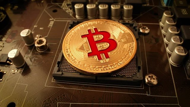 Gold Bit Coin BTC coins on the motherboard. Bitcoin is a worldwide cryptocurrency and digital payment system called the first decentralized digital currency.