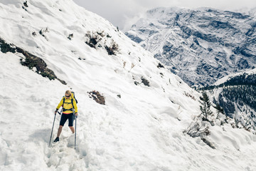Naklejka na ściany i meble Woman hiker walking in Himalaya Mountains, Nepal