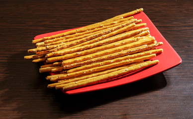 Salty bread sticks lying on the plate.