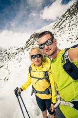 Couple hikers, partnership and teamwork in winter mountains