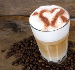 Good Morning: Close up white coffee cup on wood tab / Cup of latte art coffee with coffee beans :)