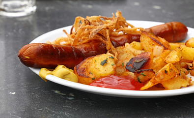 Close up portion of sausage with roasted potato