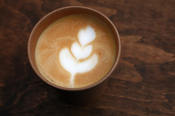 Latte cappuccino coffee in brown paper cup