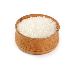 Close up wooden bowl full of white salt isolated