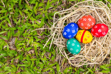 Painted Easter eggs put on the straw in the grass,easter day
