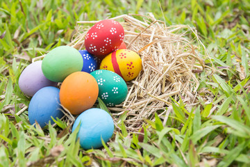 Painted Easter eggs put on the straw in the grass,easter day