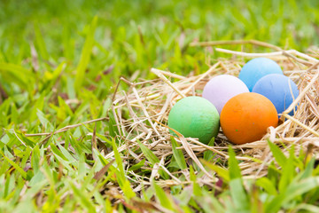 Painted Easter eggs put on the straw in the grass,easter day