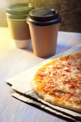 Pizza and Coffee on wooden table, cup of cappuccino.