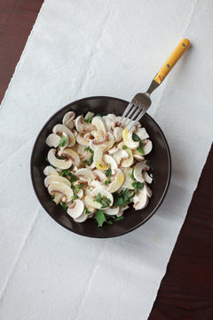 Plate with fresh mushrooms and herb