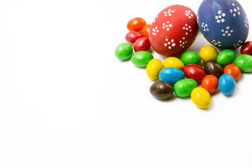 Painted Easter eggs with candy egg on white backgrou isolated