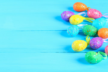 Colorful easter egg on blue pastel color wood background with space