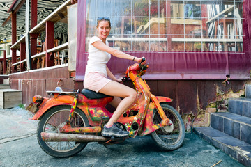 Fototapeta na wymiar Woman posing with motorbike