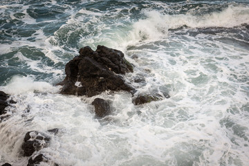 Waves hitting the rocks near Porto da Cruz on the Madeira island, Portugal