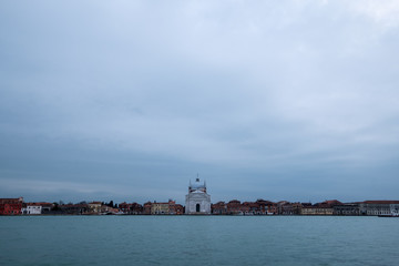 Fototapeta premium Panoramic view of La Giudecca taken from the lagoon at dusk on a cloudy winter's day, showing Church of Santissimo Redentore in the centre of the photo.