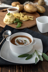 Vegetable cream soup with shrimps in bowl on table