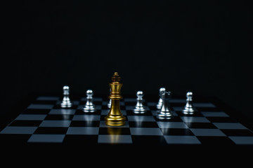 Leadership Concepts. Chess is a leader.  Comparing chess is a strategic business plan. Businessman is playing chess. Chess game on a black background.