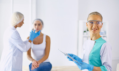 Obraz premium Permanent Makeup For Eyebrows. Beautiful Woman With Thick Brows In Beauty Salon. Beautician Doing Eyebrow Tattooing For Female Face. Beauty Procedure