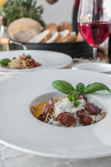 Close up low angle view of a plate of spaghetti topped with delicious bolognaise sauce