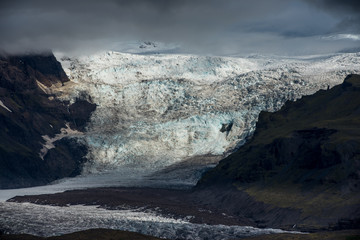 Gletscher in düsterem Licht mit grauen Wolken