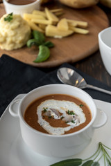 Vegetable cream soup with shrimps in bowl on table