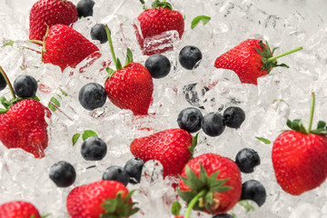 Strawberry with blueberries on ice