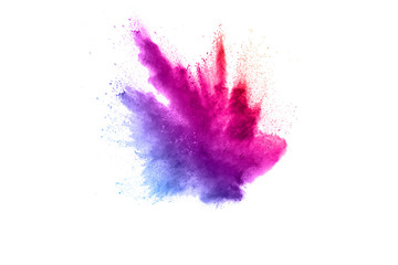 Abstract multi color powder explosion on white background.  Freeze motion of color dust  particles...