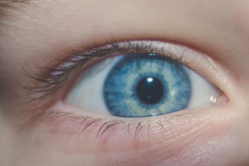 Baby blue beautiful, brooding eyes of a boy