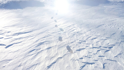 Footprints in the snow path to light the way of the future