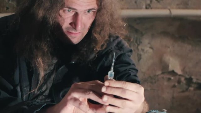 A dirty man is a drug addict injecting herself in the drugs. Methamphetamine and drugs