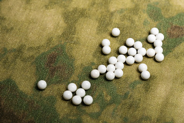 airsoft balls bbs on fabric of camouflage color