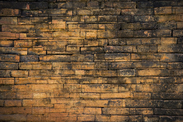 Background and Wallpaper or texture of dark discolored old brick wall ancient vintage retro style.