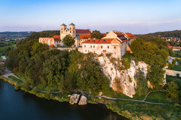 Fototapeta na wymiar Benedictine monastery on the rocky hill in Tyniec near Cracow, Poland, and Vistula River. Aerial view at sunset