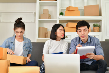 Sme business concept. Young Asian people are packing their packages.Delivery business  Small and Medium Enterprise (SMEs). Young man is working in the house.Young Owner Start up for Business Online.