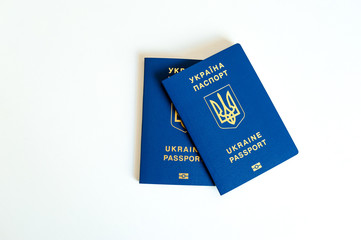 New ukrainian blue biometric passport with identification chip and old ukrainian passport on white background