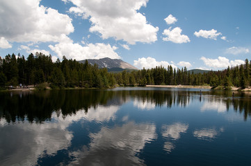 Mountain pond with puffy clouds
