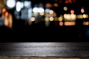 Empty wooden table platform and bokeh at night.